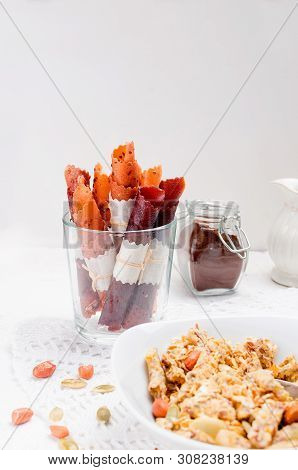 Granola From Several Types Of Cereals With Nuts,coconut Chips And Dried Fruits  In White Plate For B