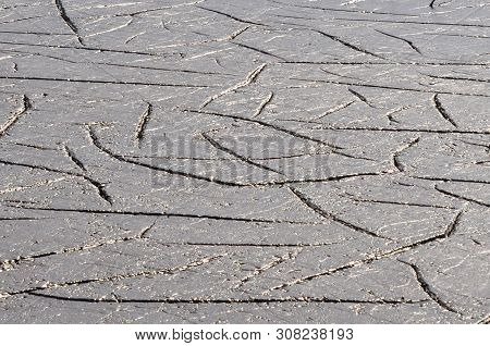 A Close-up Of The Cracked Earth Dried Up Under The Scorching Sun.