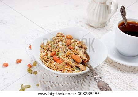 Granola From Several Types Of Cereals With Nuts,coconut Chips And Dried Fruits  In White Plate For B