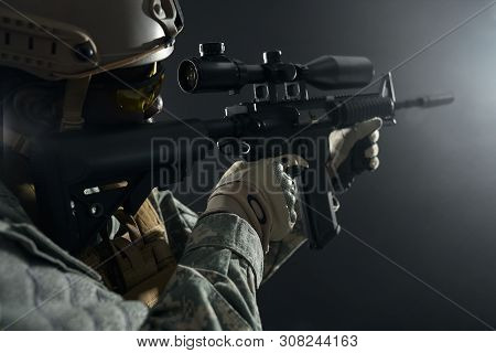 Close Up Of African Professional Soldier Shooting From Modern Long Gun Among Dark. Ranker Wearing He