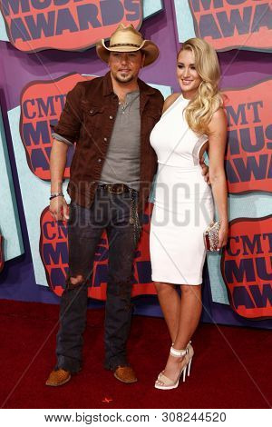 NASHVILLE, TN-JUNE 4: Country recording artist Jason Aldean (L) and Brittany Kerr attend the 2014 CMT Music Awards at the Bridgestone Arena on June 4, 2014 in Nashville, Tennessee.