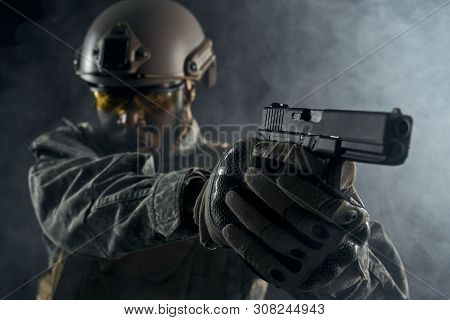 Selective Focus Of Modern Little Gun In Hands Of American Solider. Angry Ranker In Helmet And Unifor