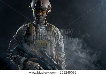 African Ranker Holding Shotgun In Hands, Keeping Position, After Shooting. American Soldier In Glass
