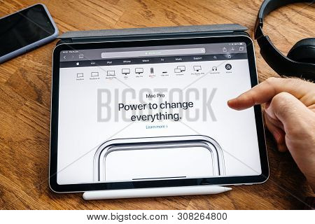 Paris, France - Jun 6, 2019: Man Reading On Apple Ipad Pro Tablet About Latest Announcement New Mac 