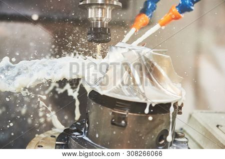 CNC milling machine work. Coolant and lubrication in gear metalwork industry