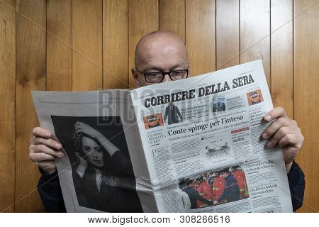 Italy, 2018.  A Man Reads The Corriere Della Sera Italian Newspaper