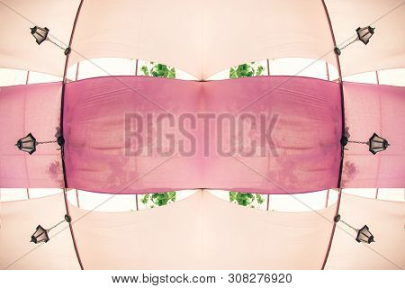 Part Of Cafe Interior. Ceiling Made Of Six Lamps And Pink And Beige Colored Silk Textile And Green L