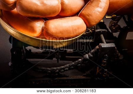 Macro Bunch Of Short Thick Wieners Rolled In Spiral On Scales