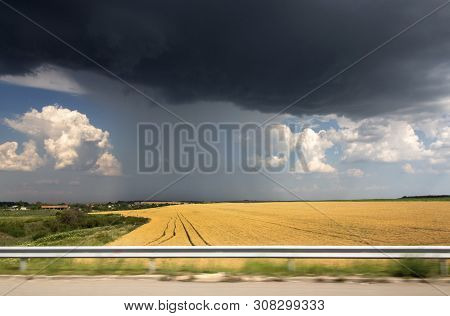 Dramatic, Stormy Sky Over Yellow Fields. A View From The Road. Trakia Motorway, Bulgaria.