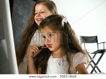 Interaction Of Children With Adult World. Cute Girls Trying To Do Bright Make Up For Being Older. Li