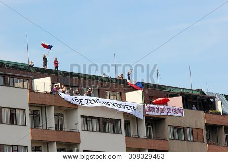 Prague, Czech Republic - June 23 2019: People On A Roof Of A Building Supporting Protests Against Pr