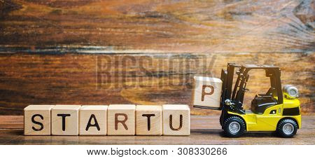 Wooden Blocks With The Word Startup. Temporary Structure Designed To Find And Implement A Scalable B