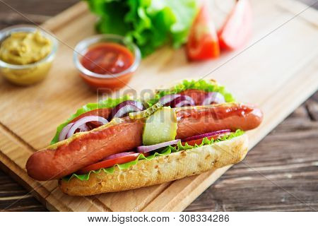 Delicious Fast Food. Hot Dog With Grilled Sausages, Onions And Vegetables.