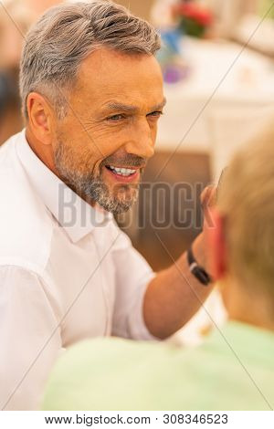 Handsome Bearded Grey-haired Man Looking At His Wife