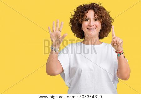 Beautiful middle ager senior woman wearing white t-shirt over isolated background showing and pointing up with fingers number six while smiling confident and happy.