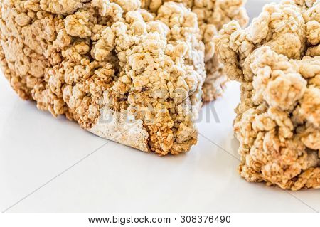 Shapeless Loaf Of Freshly Backed Sourdough Bread With Sesame Seeds On White Background.