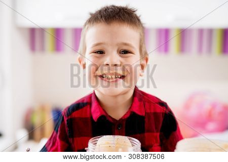 Close Up Of A Cute Young Boy Having His Mouth Smeared With Smoothie He Just Drank.
