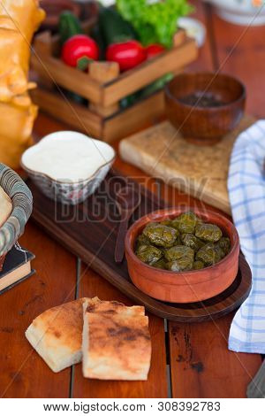 Yarpag Dolmasi, Yaprak Sarmasi, Green Grape Leaves Stuffed With Rice And Meat In Pottery Bowl With Y