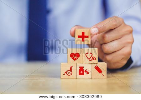 Health Insurance Concept,hand Arranging Wood Block Stacking With Icon Healthcare Medical.
