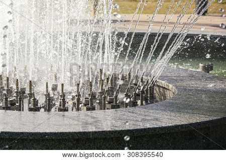 Fountain Nozzles Spraying Water. Closeup Of Fountain Nozzles Spraying Water In A Public Park