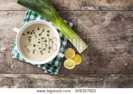 French Vichyssoise Soup In Bowl On Wooden Table. Top View. Copyspace