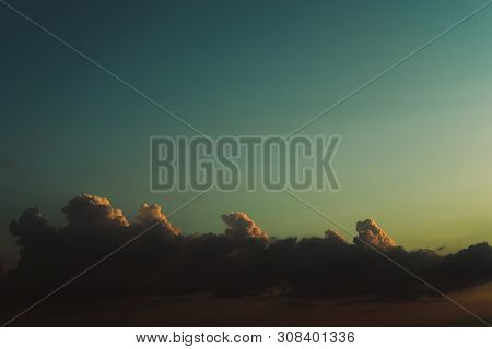Evening Sky At Sunset Background. Dark Clouds Hanging Above Horizon. Majestic Cloudscape In Blue, Or