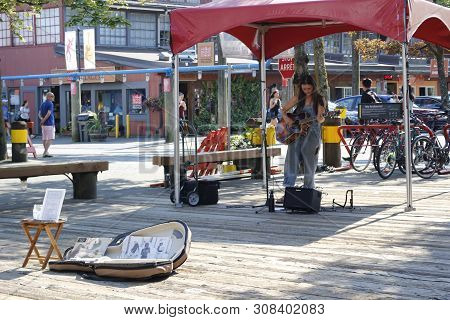June 19 2018, Vancouver Canada: Editorial Photograph Of A Female Busking On Granville Island. Buskin