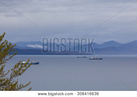 View Of The Avacha Bay. Ships Standing In The Roadstead, Mountain In The Background. Petropavlovsk-k