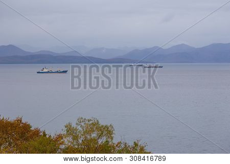 View Of The Avacha Bay. Ships Standing In The Roadstead, Mountain In The Background. Petropavlovsk-k