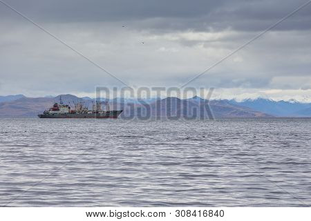 View Of The Avacha Bay. Ships Standing In The Roadstead, Mountain In The Background. Petropavlovsk-k
