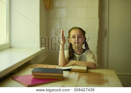 Pupil In School Uniform With Braids. Girl Schoolgirl At School With Book In School Uniform. Training
