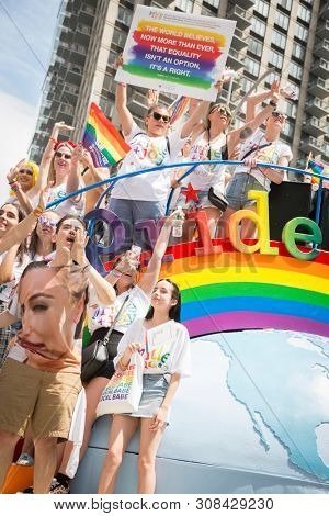 2018 JUNE 24 NEW YORK: NYC Pride March participants ride on the Macys Pride and Joy float on the 5th Ave parade route.