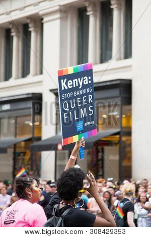 2018 JUNE 24 NEW YORK: NYC Pride March participant from HRW holds a sign that says Kenya Stop Banning Queer Films on the 5th Ave parade route.