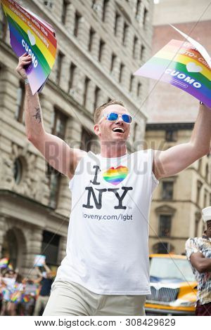 2018 JUNE 24 NEW YORK: Supporter of Democratic New York Governor Andrew Cuomo marches along the 5th Ave parade route during the NYC Pride March.