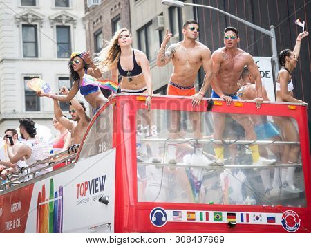 2018 JUNE 24 NEW YORK: NYC Pride March participants wearing only company brand underwear ride on the PVH parade float on 5th Ave route. Phillips-Van Heusen Corporation is an American clothing company.