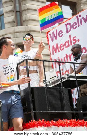 2018 JUNE 24 NEW YORK: NYC Pride March participants ride on the Gods Love We Deliver float on the 5th Ave parade route.