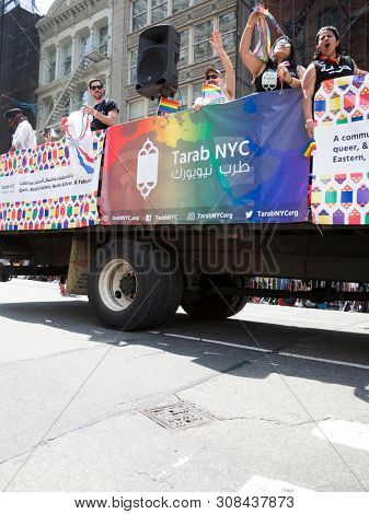 2018 JUNE 24 NEW YORK: NYC Pride March participants ride on the Tarab NYC float, a non-profit inclusive organization for Arab, Middle Eastern, and North African people, MENA, on 5th Ave.