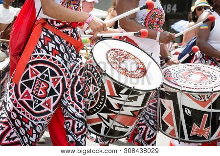 2018 JUNE 24 NEW YORK: NYC Pride March participants play drums for the cheering spectators on the 5th Ave parade route.