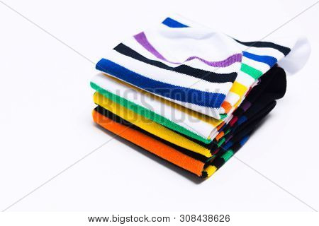Stack Of Colorful Striped Socks Over White Background. Warm Fashion Clothes For Feet. Selective Focu