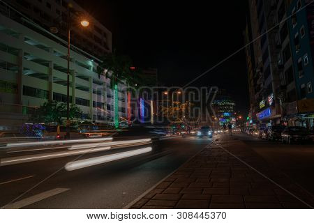 Kota Kinabalu Borneo - May 30 2019; Street Scene With Neon Lights And Light Trails From Moving Cars 