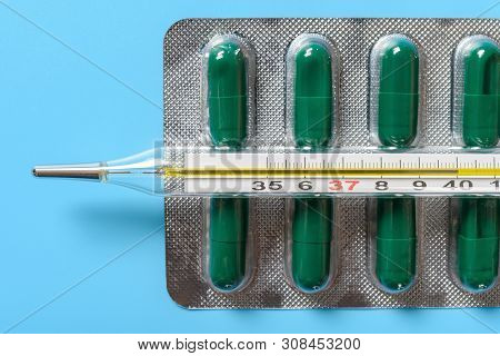 Mercury Thermometer At  40 Degrees Centigrade On Top Of Capsules