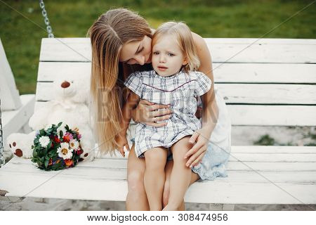 Mother With Daughter Playing In A Summer Park