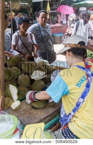 Bangkok, Thailand - 22nd April 2016: Woman Cutting Up Durian Fruit Watched By Customers On Khong Toe
