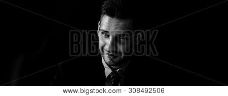 Sly Man In Formal Business Suit Staring At Interlocutor In Dark Shadow Banner Background, Black And 