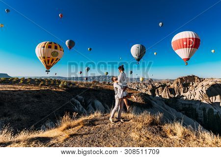 Happy Couple In Cappadocia. The Man Proposed To The Girl. Honeymoon In Cappadocia. Couple At The Bal