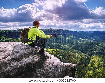 Ultralight Runner On Trail With Tracking Poles. Tired Sitting Tourist With Trekking Poles In Hand. S