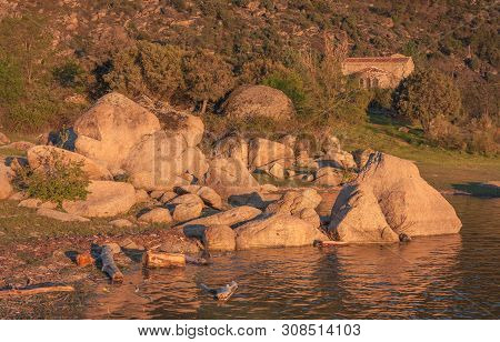 Valle Iruelas, Avila, Spain - April 7, 2014: Sunset With The View Of Some Rocks On The Shore Of The 