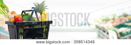 Black Shopping Basket Full Of Food And Groceries In Suppermarket Banner Background With Copy Space