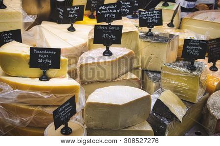 A Variety Of Cheese For Sale At The Deli Counter In A Supermarket