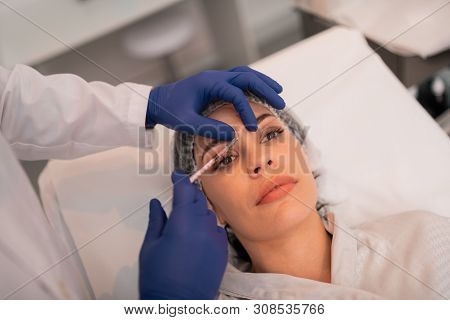 Woman Having Botox Injections While Visiting Beauty Clinic